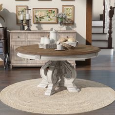 a round dining table with two chairs and a basket on the floor next to it