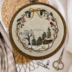 a cross stitch kit with scissors and other items