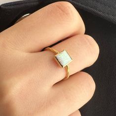 White opal ring is a new trend minimal product that you can use every day with a unique stone selected by ISEA Fine Jewelry. ➤ Ring Details * 14k / 18k Yellow Gold or Yellow Sterling Silver * Gold Color Options; 14K / 18k White, Yellow, Rose Gold * Sterling Silver Color Options; Yellow, Rose, White * Band Width: 1.45 mm * Thickness: 1.35 mm ➤ Gem Details * Gemstone : Opal * Gem color: White * Gem width: 6 millimeter * Gem length: 6 millimeter * Cut Type: Princess * Ready to Ship 3-5 Business Day Modern Yellow Gold Opal Ring Gift, Minimalist Everyday Opal Jewelry, Modern 14k Gold Opal Gemstone Ring, Stackable Opal Ring In 14k Gold For Gift, 14k Gold Stackable Opal Ring For Gift, Stackable 14k Gold Opal Ring As Gift, Gold Opal Birthstone Ring As Gift, Everyday 14k Yellow Gold Opal Ring, Adjustable 14k Gold Opal Birthstone Ring