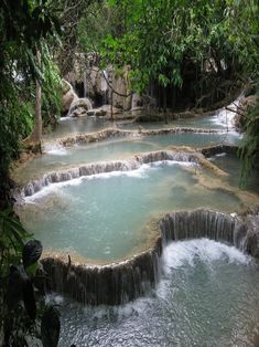 there are many small pools in the water that have waterfalls coming out of each one