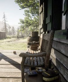 a wooden bench sitting on top of a wooden porch next to a tree filled field