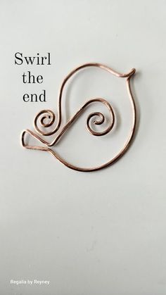 an image of a brooch with the words swirl the end on it's side