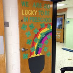 a door decorated with shamrocks and a pot of gold