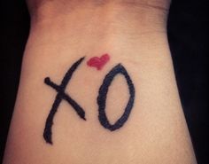 a tattoo with the word xo written on it and a heart in the middle