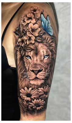 a woman's arm with a lion and flowers on it