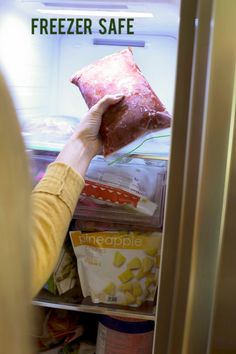 a person reaching into an open refrigerator with freezer safe items in it and the words freezer safe written on the door