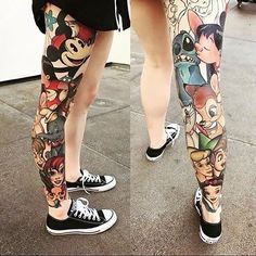 two people with tattoos on their legs and one has mickey mouses all over them