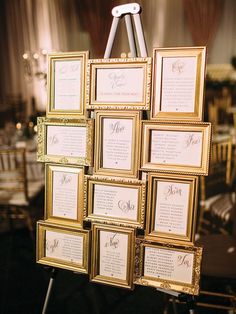 there are many framed pictures on the easer with names and date cards attached to it