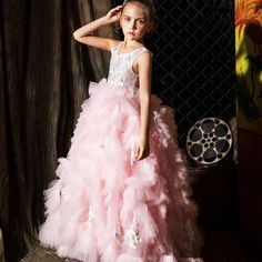 Indulge your little girl's royalty with our Dreamy Vow Pink Luxury Dubai Kids Girl Dress. This stunning ball gown features intricate Arabic appliques and tiered layers, perfect for weddings, parties, birthdays, or pageants. Give her the spotlight she deserves with this princess-worthy dress. Quinceanera Pageant Ball Gown With Ruffles, Pink Princess Pageant Dress For Debutante Ball, Ruffled Ball Gown For Debutante Ball Pageant, Ruffled Ball Gown For Debutante Ball, Tiered Tulle Princess Dress For Dress-up, Tiered Princess Dress For Wedding, Tulle Ball Gown Pageant Dress With Ruffles, Princess Style First Communion Dress With Ruffles, Princess Ball Gown First Communion Dress With Ruffles