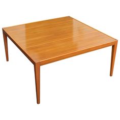 a square wooden table with no leaves on it