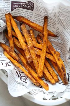 some french fries are in a basket on paper