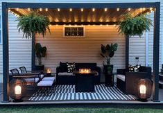 an outdoor living area is lit up with lights