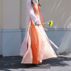 Step into a harmonious blend of history and modern fashion with the colorful Jüzi Qishui 橘子汽水 Orange Soda Changshan & Double Layered Trousers Set! The Changshan 长衫 (long shirt) is made from lightweight and breathable floral jacquard, featuring a contrast trim down the length of the jacket. Elongates the body and adds an extra layer of coverage! Side slits allow the rest of the outfit to peek through and adds ventilation, perfect for even the warmest of days. The Song Ku 宋裤 (Song Dynasty trousers Long Sleeve Orange Kimono For Spring, Traditional Spring Kimono, Traditional Pink Kimono For Spring, Traditional Spring Wedding Kimono, Traditional Long Kimono For Spring, Long Kimono For Festivals, Multicolor Spring Wedding Kimono, Traditional Kimono For Spring Tea Ceremony, Hanfu Men