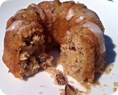 a partially eaten doughnut sitting on top of a white plate covered in icing