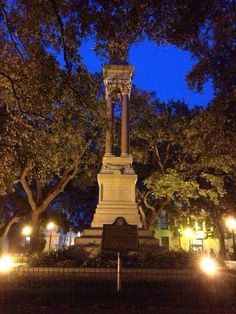 a monument in the middle of a park at night