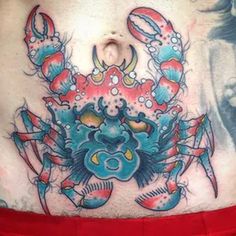 a man's stomach with a crab tattoo on it