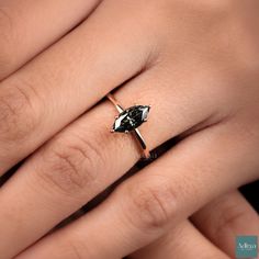 a woman's hand with a black and white diamond ring