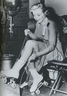 a black and white photo of a woman knitting