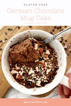 a person holding a spoon in a bowl filled with chocolate and nuts, text reads gluten free german chocolate mug cake