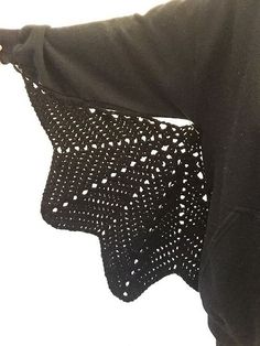 a black shirt with white dots on it