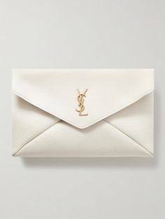 SAINT LAURENT's 'Cassandre' clutch is an instant classic you'll keep coming back to. It's made from leather with a distinct vintage-style grain and detailed with a brushed gold-tone 'YSL' monogram that only adds to its enduring appeal. Stow your phone, keys and even a notebook inside. Designer White Leather Clutch, Saint Laurent Clutch, French Bob, Luxury Clutch, Wedding Purse, Wedding Clutch, Designer Clutch, A Notebook, White Belt