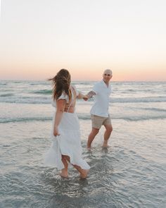 two people in the water holding hands