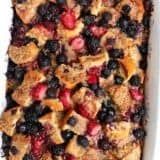 a pan filled with blueberries, raspberries and crumbled oatmeal bread