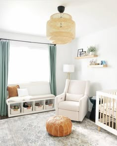 a baby's room with a crib, chair, and ottoman in it