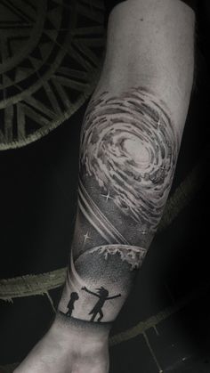 a man's arm with a tattoo on it that has an image of a person holding