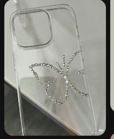 a clear phone case with an intricate design on the front and back cover, sitting on top of a table