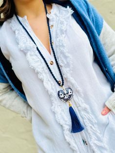 Dive into the boho-chic vibe with our captivating Boho Necklace, featuring a stunning Corazon Mexicano in blue and white made of the finest talavera mexicana. This unique piece captures the heart of Mexican artistry, giving you a slice of authentic talavera pottery to adorn your outfits. Hanging gracefully from a long, silky blue cord, the ceramic pendant is the centerpiece of this bohemian dream. It's not just any pendant; it's a burst of Mexican culture wrapped up in a jewelry piece. And let's Blue Tassel Necklace, Artisan Blue Jewelry For The Beach, Artisan Blue Jewelry For Beach, Traditional Blue Jewelry For Beach, Traditional Blue Beach Jewelry, Blue Bohemian Necklaces For Vacation, Traditional Blue Necklaces For Beach, Blue Bohemian Necklace, Traditional Blue Necklace For Beach