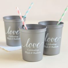 three cups with straws in them sitting next to each other on a table top