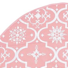 a pink and white table cloth with snowflakes on it's edges