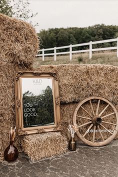 an old wagon and hay with a sign on it