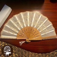 a fan sitting on top of a wooden table