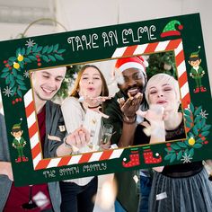 two people holding up a christmas photo frame