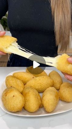 a woman is cutting up some food on a plate