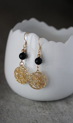 These beautiful geometric earrings was made of black matt onyx stone 8 mm beads, tiny gold tone czech glass beads, gold tone round charms and gold tone stainless steel earring hooks. Earring hooks are from nickel free and lead free metal. The total lenght of earrings is 60 mm including earring hooks. Other earrings of my shop you can see here: https://www.etsy.com/shop/NaTavelli?section_id=13757927 Thanks for visit! Black Gold-plated Pierced Earrings, Black Gold-plated Earrings, Elegant Metal Beaded Earrings With Round Beads, Elegant Round Beaded Metal Earrings, Elegant Brass Beaded Earrings With Round Beads, Elegant Brass Beaded Earrings, Elegant Black Bead Drop Earrings, Black Gold-plated Earrings For Gift, Gold Onyx Pierced Earrings