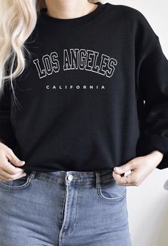 This Los Angeles Sweater is everything you've dreamed of and more. It feels soft and lightweight, with the right amount of stretch. It's comfortable and flattering for both men and women. * 100% combed and ring-spun cotton (Heather colors contain polyester) * Ash color is 99% combed and ring-spun cotton, 1% polyester * Heather colors are 52% combed and ring-spun cotton, 48% polyester * Athletic and Black Heather are 90% combed and ring-spun cotton, 10% polyester * Heather Prism colors are 99% co Los Angles Sweat Shirt, Everyday Long Sleeve Tops With Lettering, Long Sleeve Tops With Lettering For Everyday, Trendy Crew Neck Hoodie With Lettering, Trendy Loungewear Tops With Lettering, Trendy Lettering Tops For Loungewear, Trendy Letter Print Sweater For Everyday, Trendy Everyday Sweater With Letter Print, Cozy Fit Crew Neck Top With Letter Print