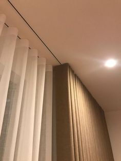 the light is on above the curtain in the room that has no curtains or blinds