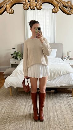 Cute fall outfit with white pleated skirt, tan cream sweater, and tall brown boots. Brown boots outfit for fall, fall style, fall outfit, transitional style, fall aesthetic, fall look, tall brown boots, new england autumn Skirt Sweater And Boots Outfit, Fall Cute Outfits Dressy, Cute Fall Dressy Outfits, Brown Boots With Tights Outfit, Styling White Boots Fall, White Pleated Skirt Outfit Fall, Brown Gogo Boots Outfit, Fall Outfit White Skirt, Long Tan Boots Outfit