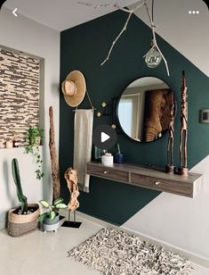 a green and white room with a mirror on the wall next to a cactus plant