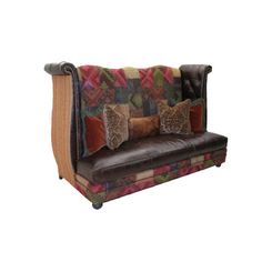 a brown leather couch with colorful pillows on it's arm and backrests