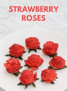 strawberries are arranged on a white plate with the words strawberry roses in red lettering