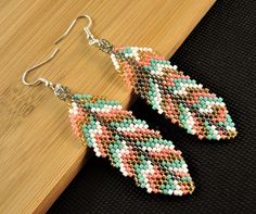 Welcome to Kartika Earrings Australia. You are buying, 1 Pair of Handmade Beaded Dangle Fashion Earrings. BEADED SHAPE - Leaf BEADED PATTERN SIZE - 65mm Long X 23mm Wide OVERALL EARRING LENGTH - 80mm Long BEAD COLOURS - Multi Colours SILVER COLOUR HOOKS - LEAD FREE, NICKEL FREE, CADMIUM FREE ALL OUR EARRINGS ARE HANDMADE IN AUSTRALIA We post every morning and afternoon. Please allow 3 - 10 days postage time within Australia. Please allow 10 - 28 days postage Worldwide. Thank you Regards Kartika Motifs Perler, Brick Stitch Earrings, Brick Stitch, Leaf Shapes, Earrings Silver, Beading Patterns, Fashion Earrings, Silver Color, Jewelry Earrings Dangle