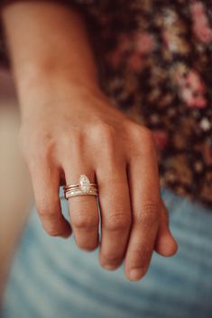 a close up of a person's hand with a ring on it