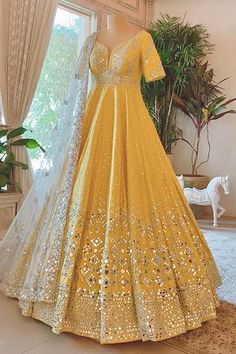 Yellow anarkali with all-over geometric motif mirror embellishments. Comes with embroidered dupatta.
Components:2
Embroidered
Neckline:Leaf
Sleeve Length:Long
Color:Yellow
Plunging neck - Aza Fashions Haldi Outfits, Wedding Lehenga Designs, Traditional Indian Dress, Pakistani Fancy Dresses, Indian Dresses Traditional, Indian Bridal Dress, Indian Gowns Dresses, Indian Gowns, Indian Bridal Outfits