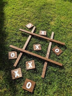 wooden tic - tacs laid out on the grass