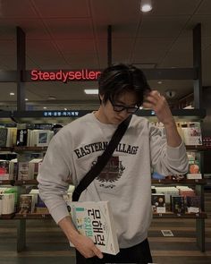 a man standing in front of a book store