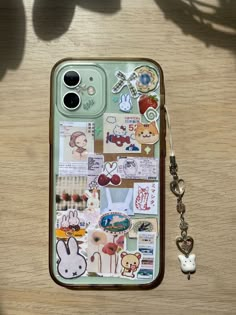 an iphone case with stickers on it and a keychain hanging from the back